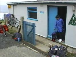 Clyde takes his panniers to his bike at Perranporth YH